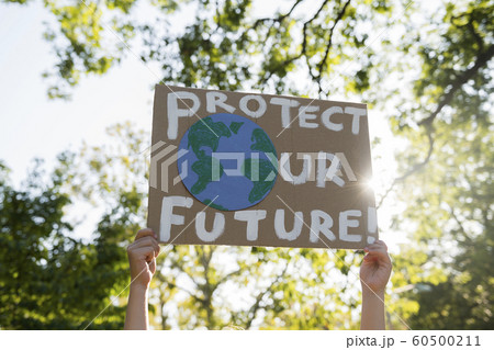 Climate change activist holding sign Climate change activist holding sign 60500211