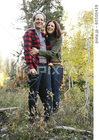 Couple smiling in forest Couple smiling in forest 60500439