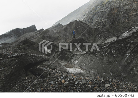Man walking on rock in Skaftafell, Iceland 60500742