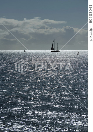 Sailboat against the glare of the sun in the sea . 60503041