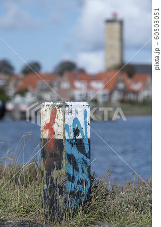 Colored bollard in the port of Terschelling . 60503051