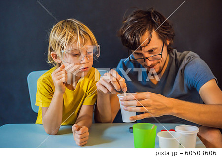 Father and son conduct chemical experiments at home. Home made slime 60503606