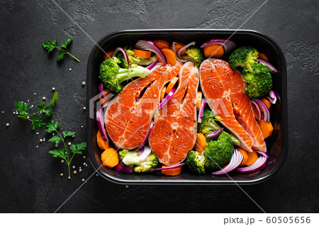 Salmon. Cooking fresh raw salmon fish steaks 60505656