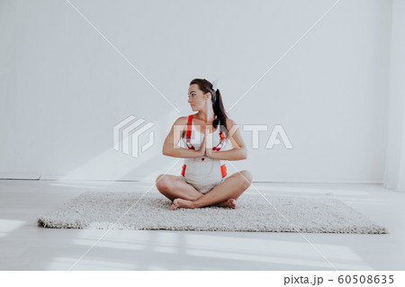 a pregnant woman is engaged in gymnastics and yoga 60508635