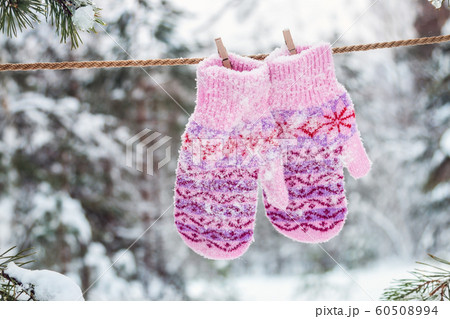 wool Christmas hanging mittens in the winter forest 60508994