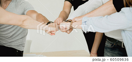 Many fists of a group of people showing team connection 60509636