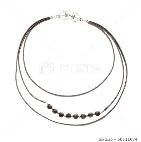 leather strip and bone beads necklace isolated leather strip and bone beads necklace isolated 60511074
