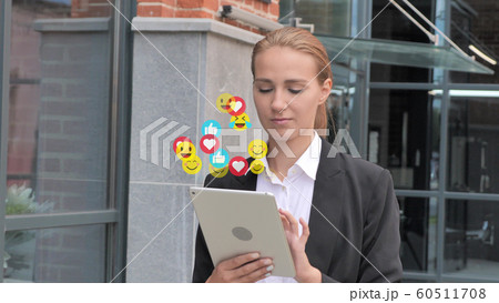 Walking Young Businesswoman Using Tablet on Her Way to Office, Flying Smileys, Emojis and Likes Walking Young Businesswoman Using Tablet on Her Way to Office, Flying Smileys, Emojis and Likes 60511708