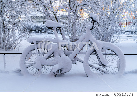 After a very heavy snowfall in the courtyard of Kronstadt remained snow-covered bike. After a very heavy snowfall in the courtyard of Kronstadt remained snow-covered bike. 60513972