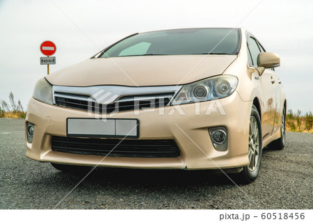 Photo of a car of golden color standing on the Photo of a car of golden color standing on the 60518456