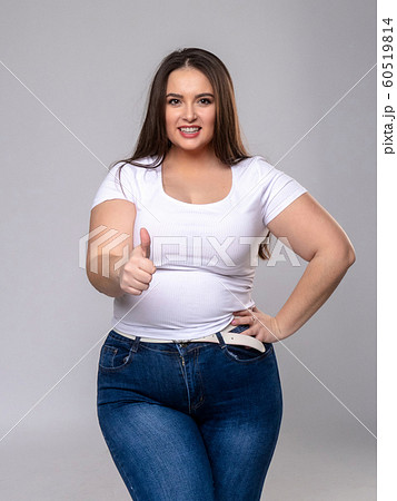 Plus Size Model with long hair posing in studio. 60519814