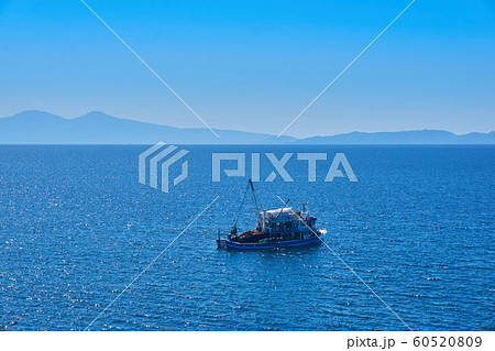 Fishing boat on the water catching fish 60520809