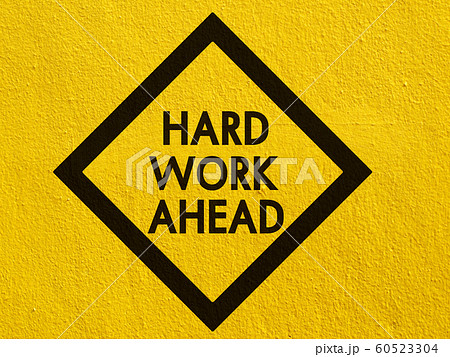 Hard work ahead street sign painted on a stucco 60523304