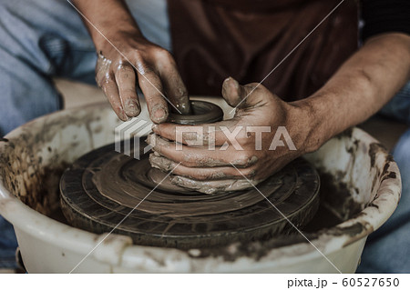 Hands of craftsman artist working on pottery 60527650