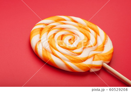 A large yellow Lollipop, on a scarlet background. A large yellow Lollipop, on a scarlet background. 60529208