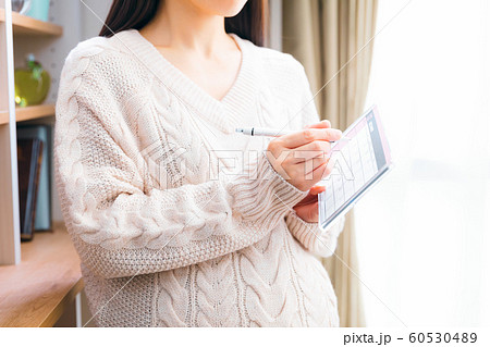 12月 カレンダーに書き込む妊婦 60530489