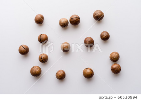 Closed macadamia nuts on a white background Closed macadamia nuts on a white background 60530994