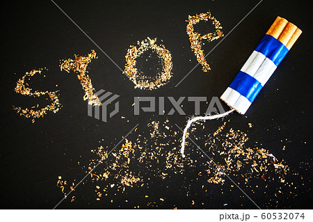 Stop smoking concept on background with broken cigarettes. Heap of cigarettes. No smoking Stop smoking concept on background with broken cigarettes. Heap of cigarettes. No smoking 60532074