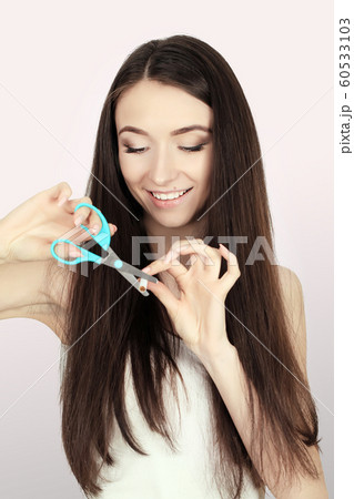 Stop smoking concept. Young woman cut cigarettes with scissors happy smiling. focus on hand, scissors and cigarettes 60533103