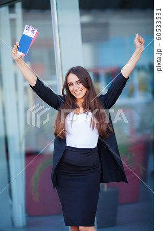 Travel. Woman holding two air ticket in abroad passport near airport 60533531