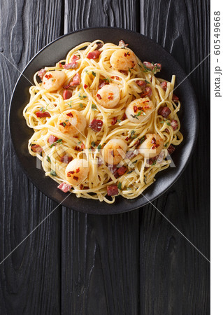 Spaghetti with seafood scallops and bacon in a Spaghetti with seafood scallops and bacon in a 60549668