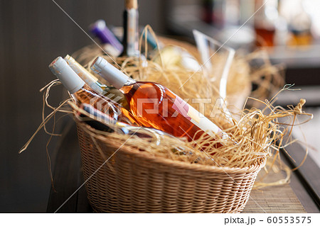 bottles of wine standing horizontally in a beautiful basket. bottles of wine standing horizontally in a beautiful basket. 60553575