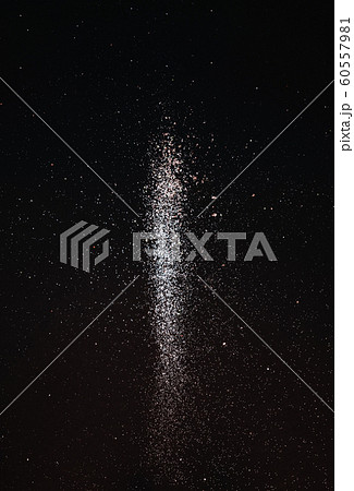 Explosion of golden sparkling flying sparkles on a black holiday background. Abstract festive background for holidays, promotions and sales. Minimalism 60557981