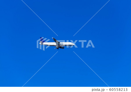 Commercial airplane flying in a beautiful blue sky Commercial airplane flying in a beautiful blue sky 60558213