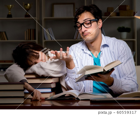 The two students studying late preparing for exams 60559317