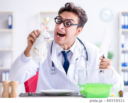 Mad crazy doctor preparing to eat rabbit Mad crazy doctor preparing to eat rabbit 60559321