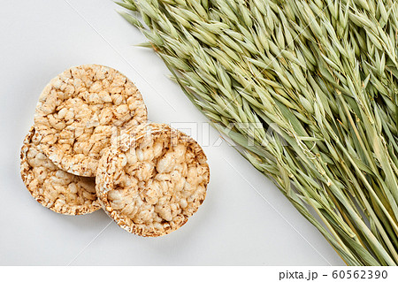 Background with crispbread and oat ears. Background with crispbread and oat ears. 60562390