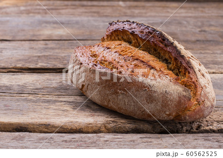 Loaf of natural bread on rustic background. Loaf of natural bread on rustic background. 60562525