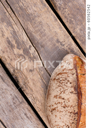 Loaf of homemade bread on rustic wooden background. Loaf of homemade bread on rustic wooden background. 60562542
