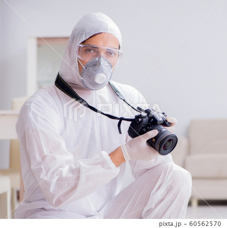 Forensic expert at crime scene doing investigation 60562570