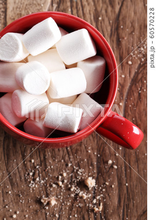 marshmallows in red cup on wooden table marshmallows in red cup on wooden table 60570228