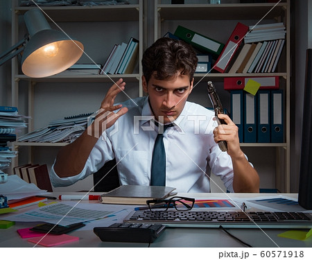Man businessman working late hours in the office Man businessman working late hours in the office 60571918