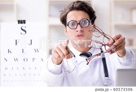 Funny eye doctor in humourous medical concept Funny eye doctor in humourous medical concept 60573506