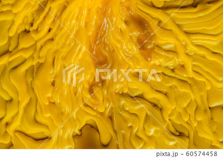 Top view of the candle melts droplets dissolve in yellow from lighted candlestick on the floor Top view of the candle melts droplets dissolve in yellow from lighted candlestick on the floor 60574458