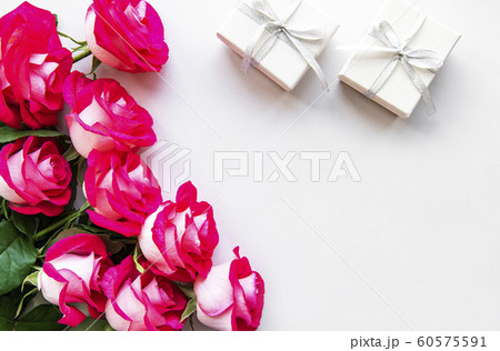 Red roses and gift boxes on a white background Red roses and gift boxes on a white background 60575591