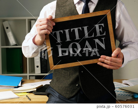 Title Loan inscription in the hands of a man. 60576031