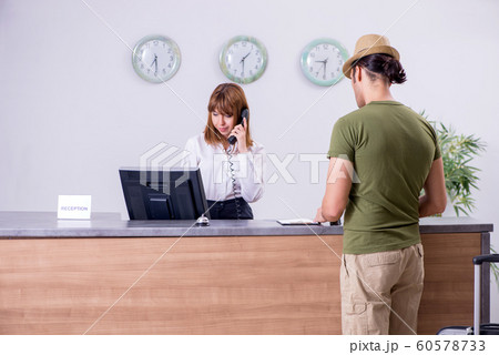 Young man at the hotel reception Young man at the hotel reception 60578733