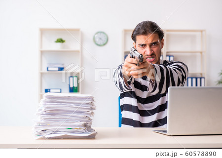 Young employee feeling like prisoner at work Young employee feeling like prisoner at work 60578890