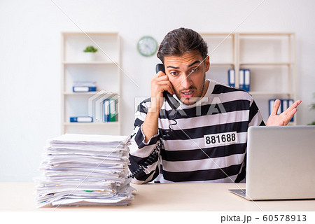 Young employee feeling like prisoner at work 60578913