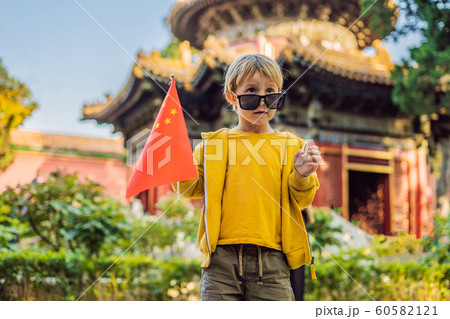 Enjoying vacation in China. Young boy with national chinese flag in Forbidden City. Travel to China with kids concept. Visa free transit 72 hours, 144 hours in China 60582121