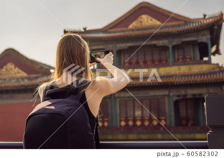 Enjoying vacation in China. Young woman in Forbidden City. Travel to China concept. Visa free transit 72 hours, 144 hours in China Enjoying vacation in China. Young woman in Forbidden City. Travel to China concept. Visa free transit 72 hours, 144 hours in China 60582302