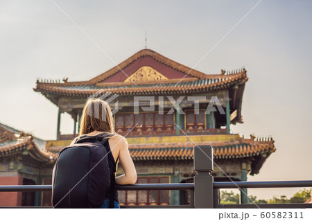 Enjoying vacation in China. Young woman in Forbidden City. Travel to China concept. Visa free transit 72 hours, 144 hours in China Enjoying vacation in China. Young woman in Forbidden City. Travel to China concept. Visa free transit 72 hours, 144 hours in China 60582311