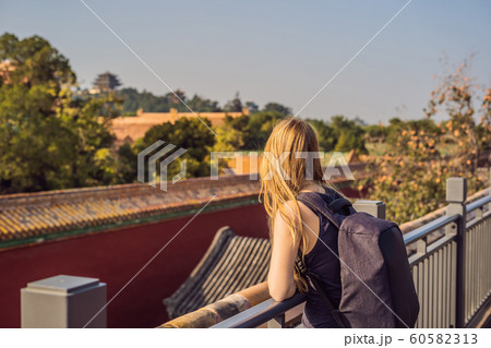 Enjoying vacation in China. Young woman in Forbidden City. Travel to China concept. Visa free transit 72 hours, 144 hours in China Enjoying vacation in China. Young woman in Forbidden City. Travel to China concept. Visa free transit 72 hours, 144 hours in China 60582313