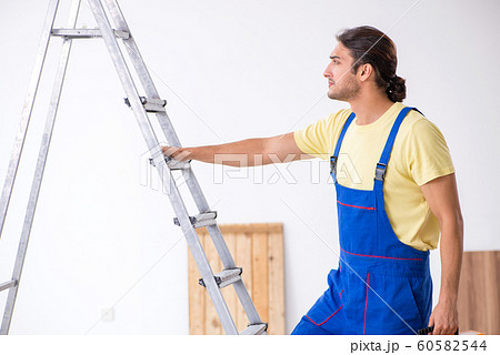 Young male contractor working indoors 60582544