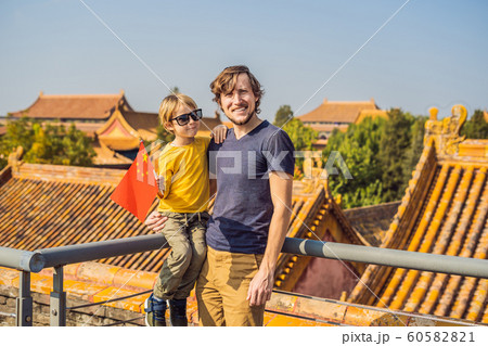 Enjoying vacation in China. Happy family with national chinese flag in Forbidden City. Travel to China with kids concept. Visa free transit 72 hours, 144 hours in China 60582821