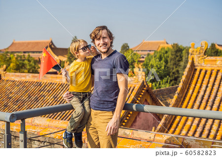 Enjoying vacation in China. Happy family with national chinese flag in Forbidden City. Travel to China with kids concept. Visa free transit 72 hours, 144 hours in China 60582823